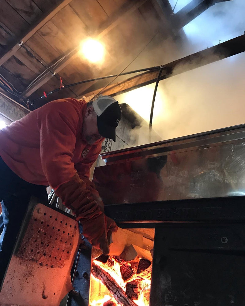 Ryan Annetts loading the evaporator with firewood