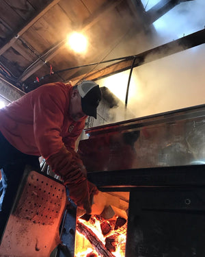 Ryan Annetts loading the evaporator with firewood