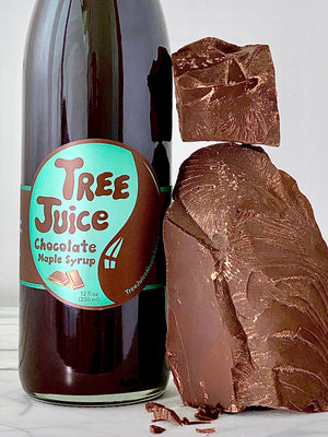 12oz bottle of Tree Juice Chocolate Maple syrup with blocks of chocolate