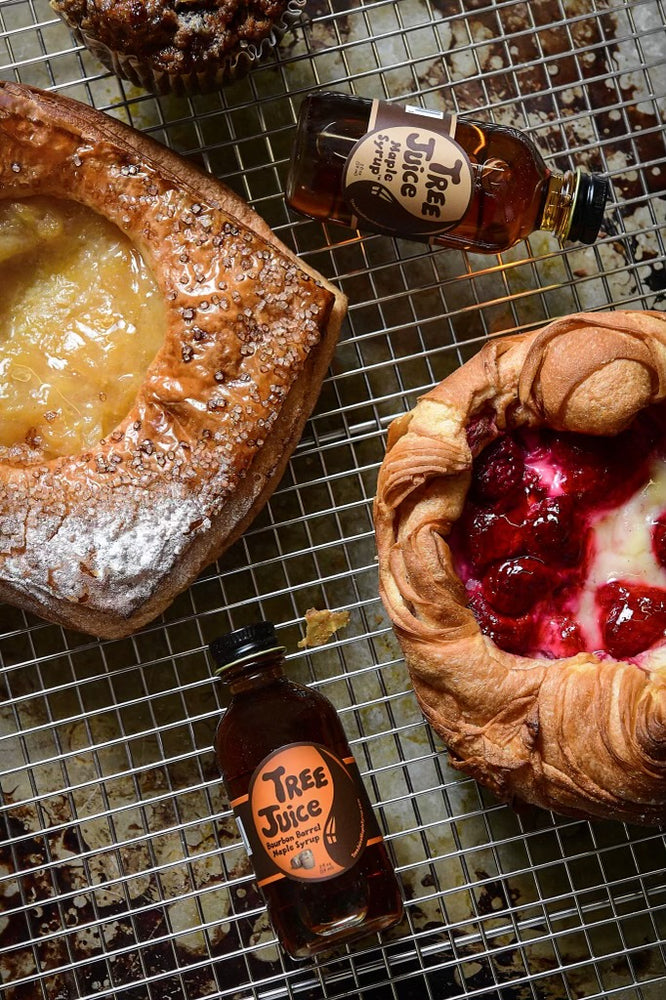 baked goods with 2oz bottles of Tree Juice Maple Syrup