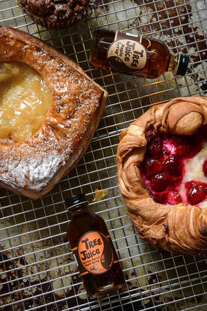 baked goods with 2oz bottles of Tree Juice Maple Syrup