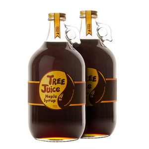 Two 64oz bottles of Tree Juice Maple Syrup