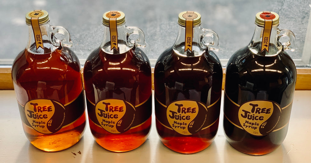 Four 64oz bottles of Tree Juice Maple Syrup